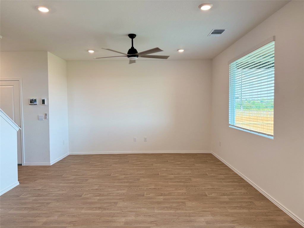 224 Inks Lane Kyle, TX 78640 - Photo 8 of 13 wooden floor in an empty room with a window