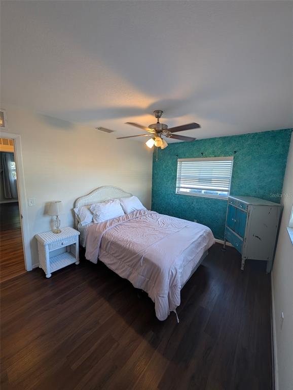 1460 Ruth Road Dunedin, FL 34698 - Photo 12 of 27 a bedroom with a bed and a chandelier