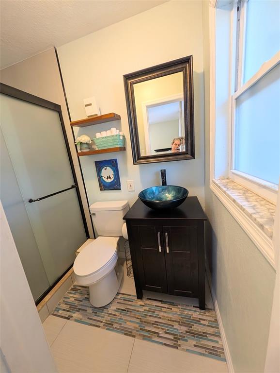 1460 Ruth Road Dunedin, FL 34698 - Photo 15 of 27 a bathroom with a toilet a sink and a mirror
