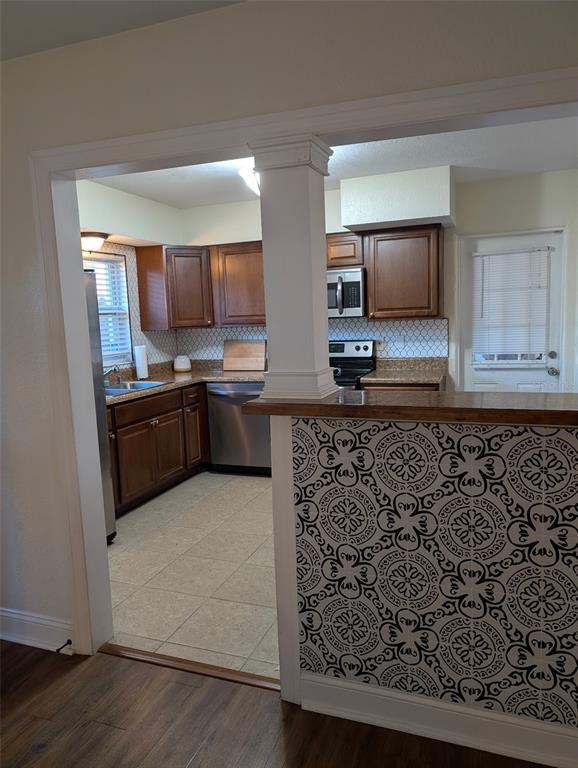 1460 Ruth Road Dunedin, FL 34698 - Photo 19 of 27 a kitchen with stainless steel appliances granite countertop a sink and a microwave