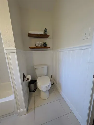 a white toilet sitting next to a small sink