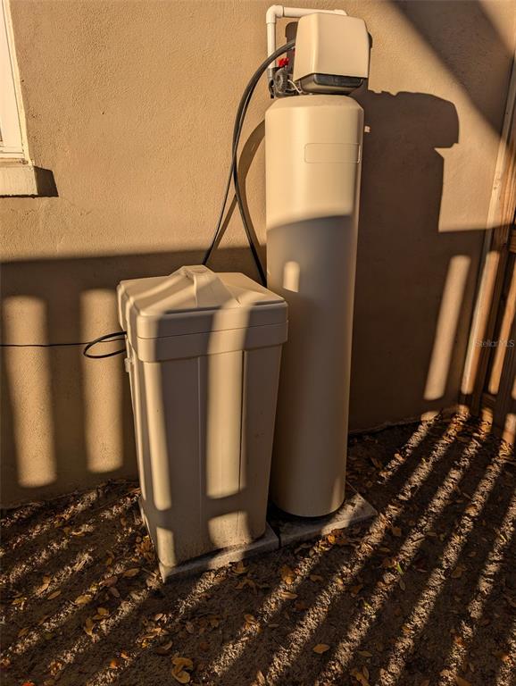 1460 Ruth Road Dunedin, FL 34698 - Photo 22 of 27 a utility room with water heater and racks