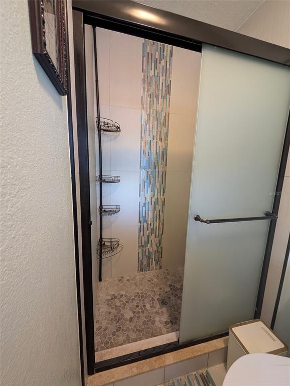 1460 Ruth Road Dunedin, FL 34698 - Photo 10 of 27 a bathroom with a glass door