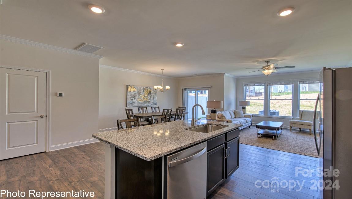 538 Wheatfield Road Fletcher, NC 28732 - Photo 12 of 44 a kitchen with granite countertop a sink and dishwasher with a dining table