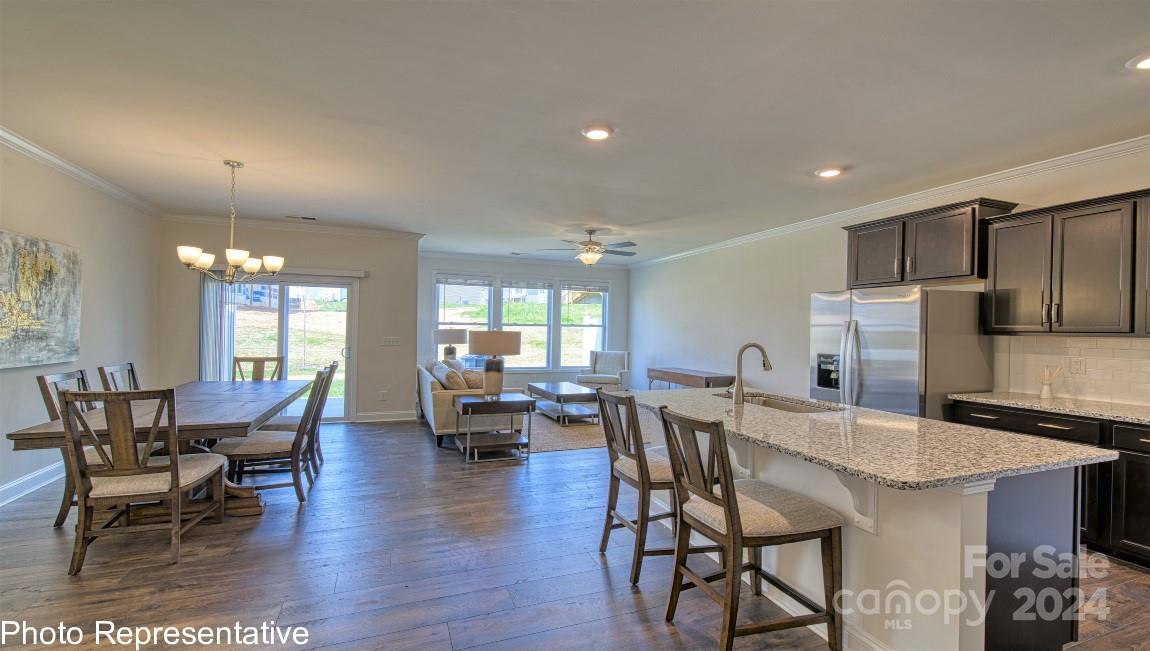 538 Wheatfield Road Fletcher, NC 28732 - Photo 14 of 44 a view of a dining room with furniture and wooden floor