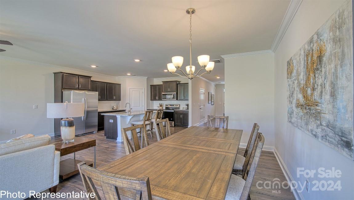 538 Wheatfield Road Fletcher, NC 28732 - Photo 20 of 44 a view of a dining room and a kitchen with a table chairs