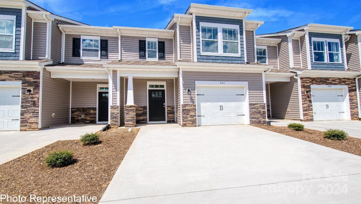 538 Wheatfield Road Fletcher, NC 28732 - Photo 2 of 44 a front view of a house with a yard and garage