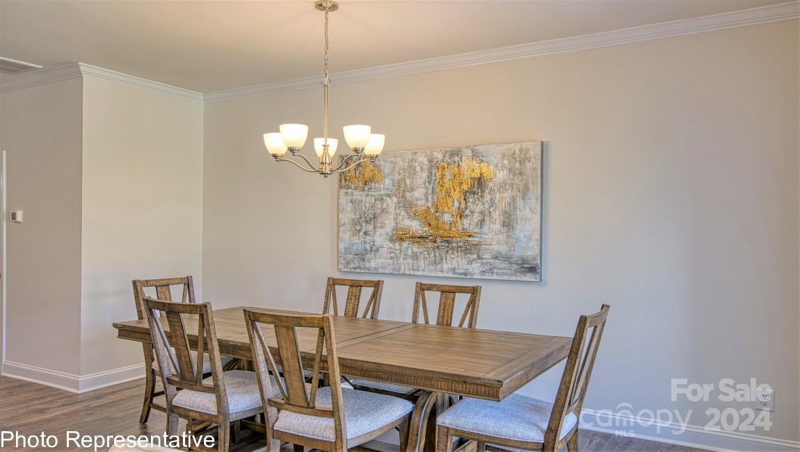 538 Wheatfield Road Fletcher, NC 28732 - Photo 21 of 44 a view of a dining room with furniture and chandelier