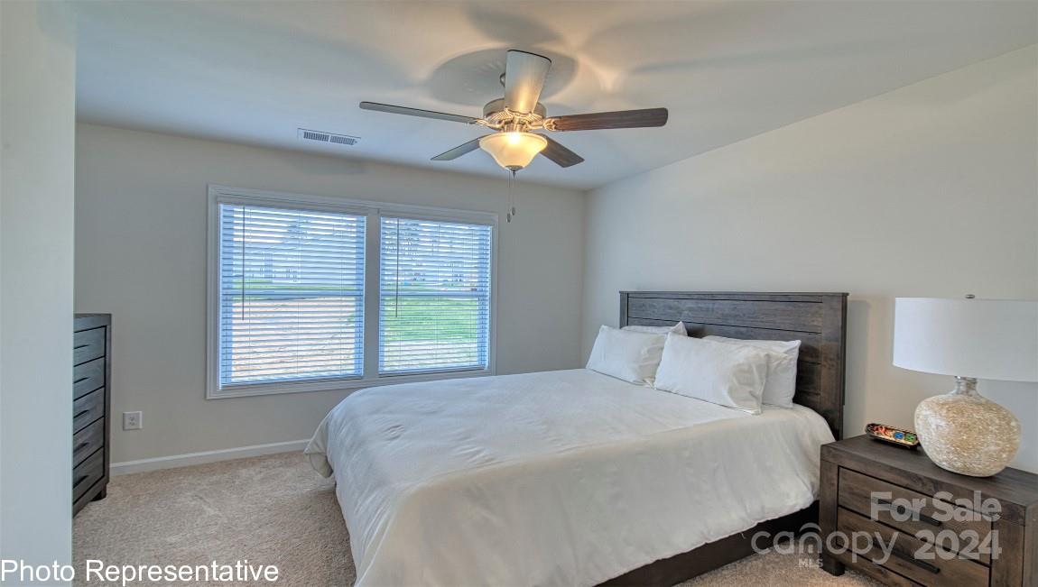 538 Wheatfield Road Fletcher, NC 28732 - Photo 26 of 44 a bedroom with a bed and a chandelier