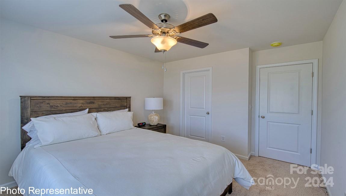 538 Wheatfield Road Fletcher, NC 28732 - Photo 28 of 44 a bedroom with a bed and a ceiling fan