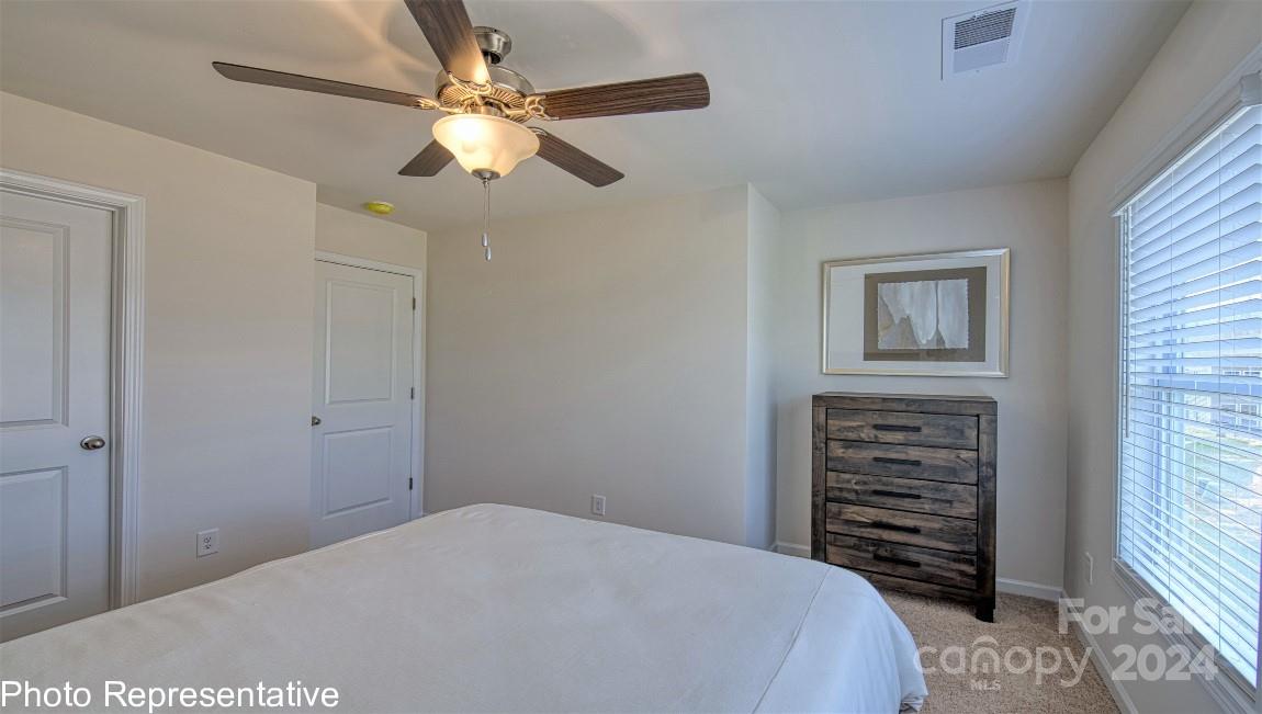 538 Wheatfield Road Fletcher, NC 28732 - Photo 29 of 44 a bedroom with a bed and a chandelier