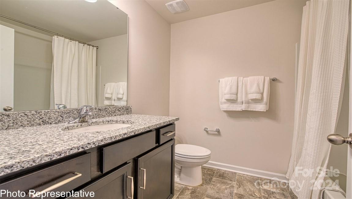 538 Wheatfield Road Fletcher, NC 28732 - Photo 30 of 44 a bathroom with a granite countertop sink and a toilet
