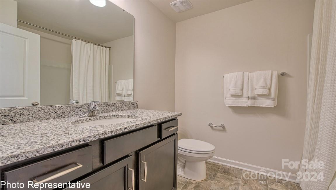 538 Wheatfield Road Fletcher, NC 28732 - Photo 31 of 44 a bathroom with a granite countertop sink and a toilet