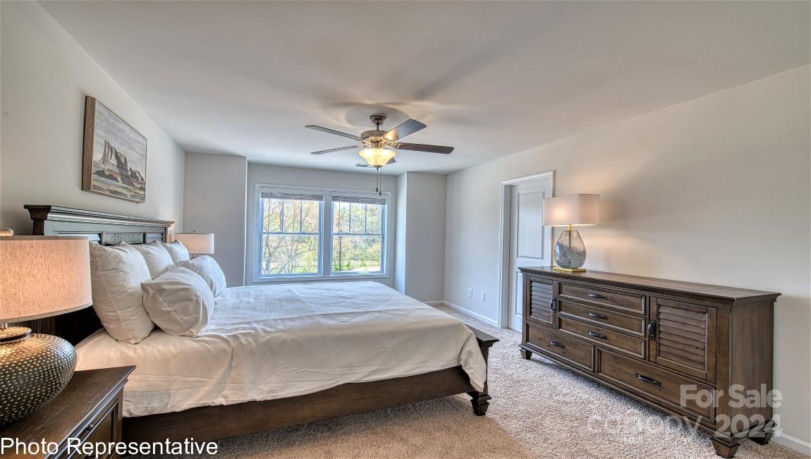 538 Wheatfield Road Fletcher, NC 28732 - Photo 38 of 44 a bedroom with a bed and a chandelier