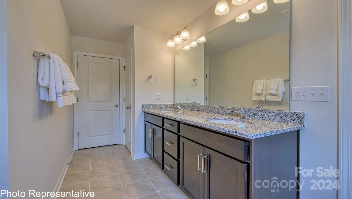 538 Wheatfield Road Fletcher, NC 28732 - Photo 41 of 44 a bathroom with a granite countertop sink a large mirror and a shower