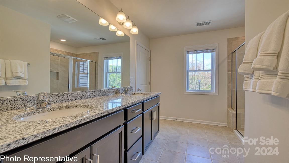 538 Wheatfield Road Fletcher, NC 28732 - Photo 43 of 44 a bathroom with a granite countertop sink and a mirror