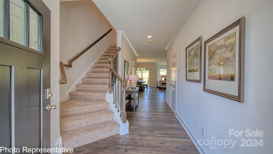 538 Wheatfield Road Fletcher, NC 28732 - Photo 6 of 44 a view of a hallway with wooden floor and stairs