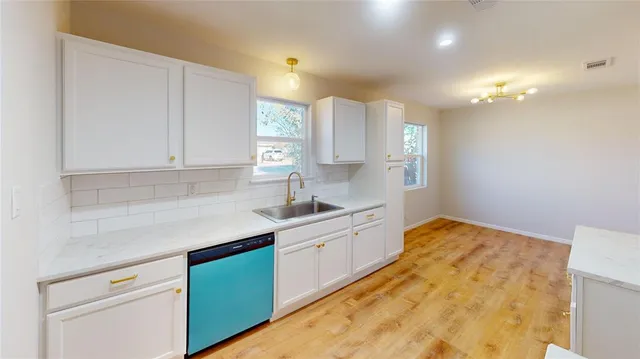 a kitchen with a sink cabinets and window