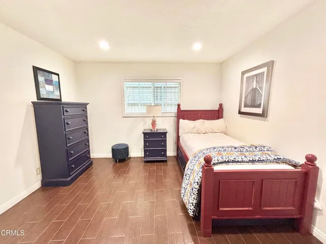 a bedroom with a bed and a dresser