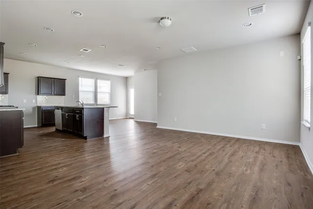a view of a kitchen with wooden floor and a sink