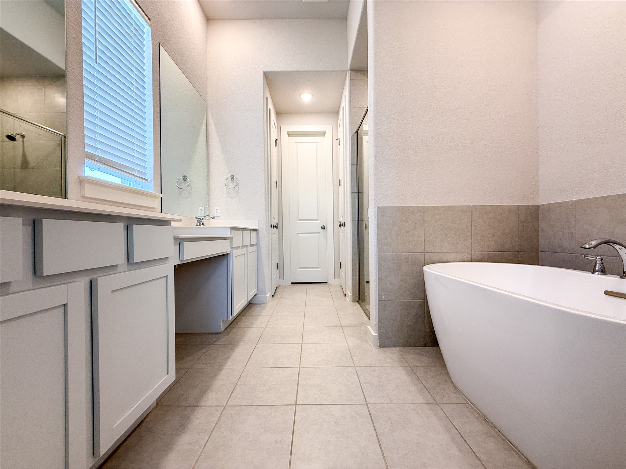 249 Heartleaf Road San Marcos, TX 78666 - Photo 16 of 38 Luxurious soaking tub and dual vanity complete this elegant bath retreat.