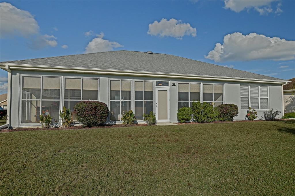 9203 Southeast 130th Loop Summerfield, FL 34491 - Photo 6 of 90 a front view of a house with a garden