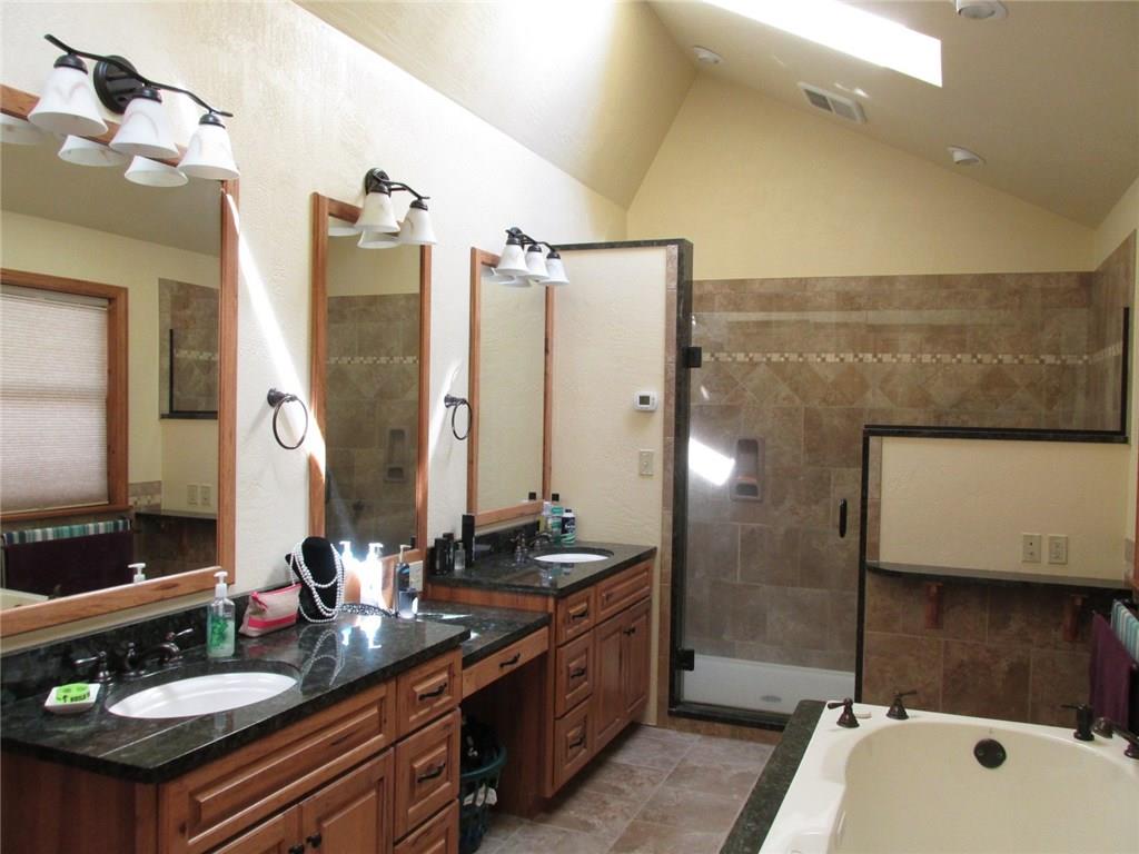 243 Baer Ridge Road Somerset, PA 15501 - Photo 14 of 25 Stunning! Granite counters, ceramic surround shower with upgraded faucets and shower heads, skylight, upgraded lighting fixtures and a jetted tub!