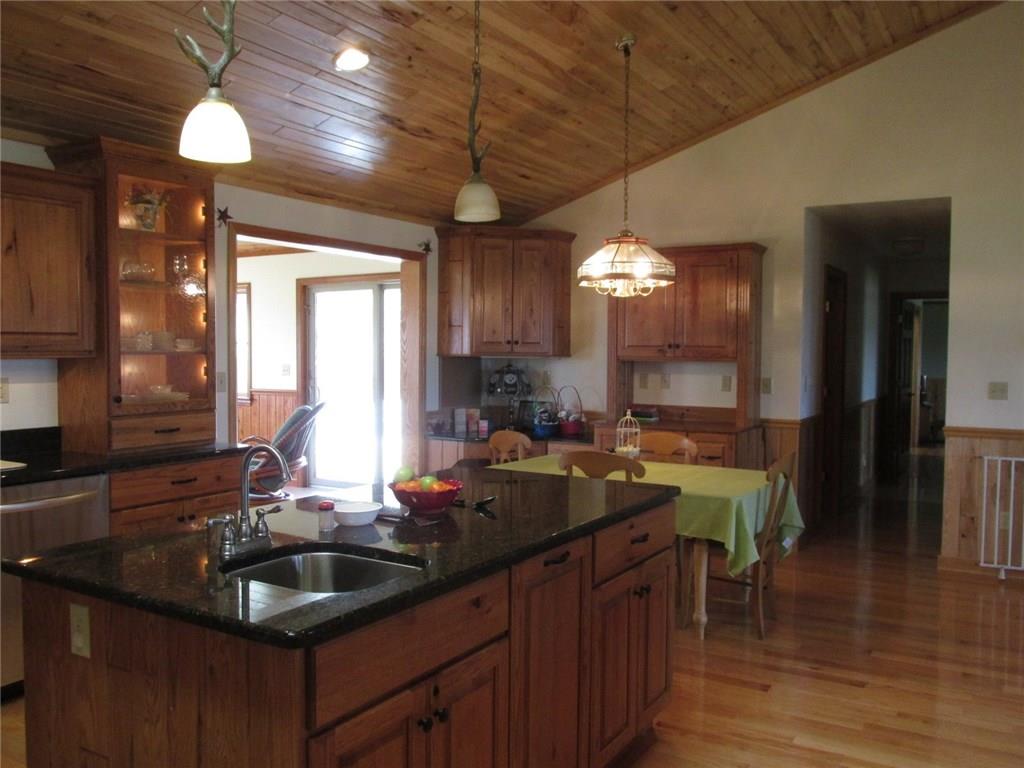 243 Baer Ridge Road Somerset, PA 15501 - Photo 5 of 25 These are solid rustic oak cabinets! Here you can see the hardware and upgraded lighting. In the back left corner you can see a work space for planning your day. Through the open space to the left is the living room. The hall way to the right leads back to the master bedroom and another bedroom and bath.