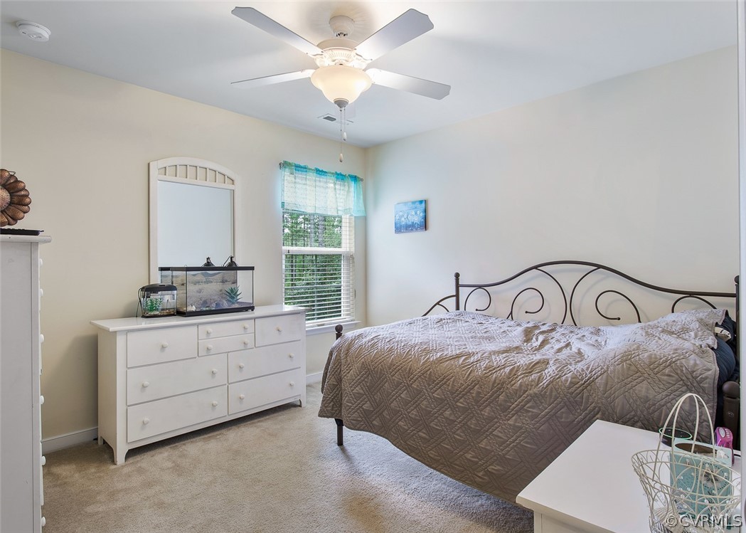 12011 Winterpock Road Chesterfield, VA 23838 - Photo 25 of 33 a bedroom with a large bed and a chandelier