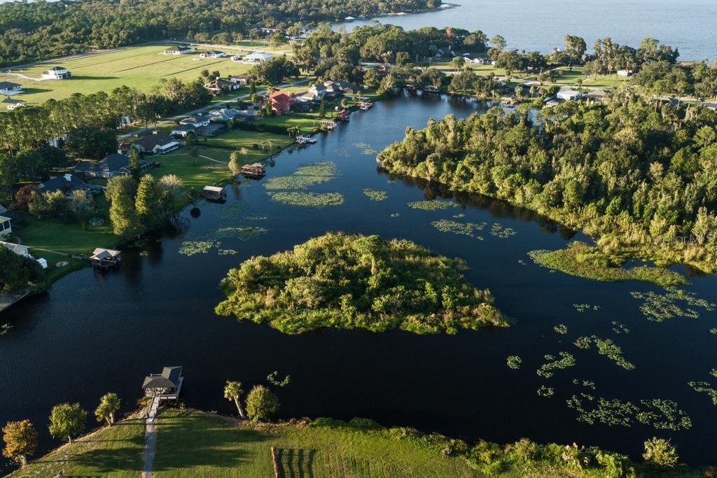 3430 Lake Diane Road Tavares, FL 32778 - Photo 19 of 21 a view of a lake with lawn chairs