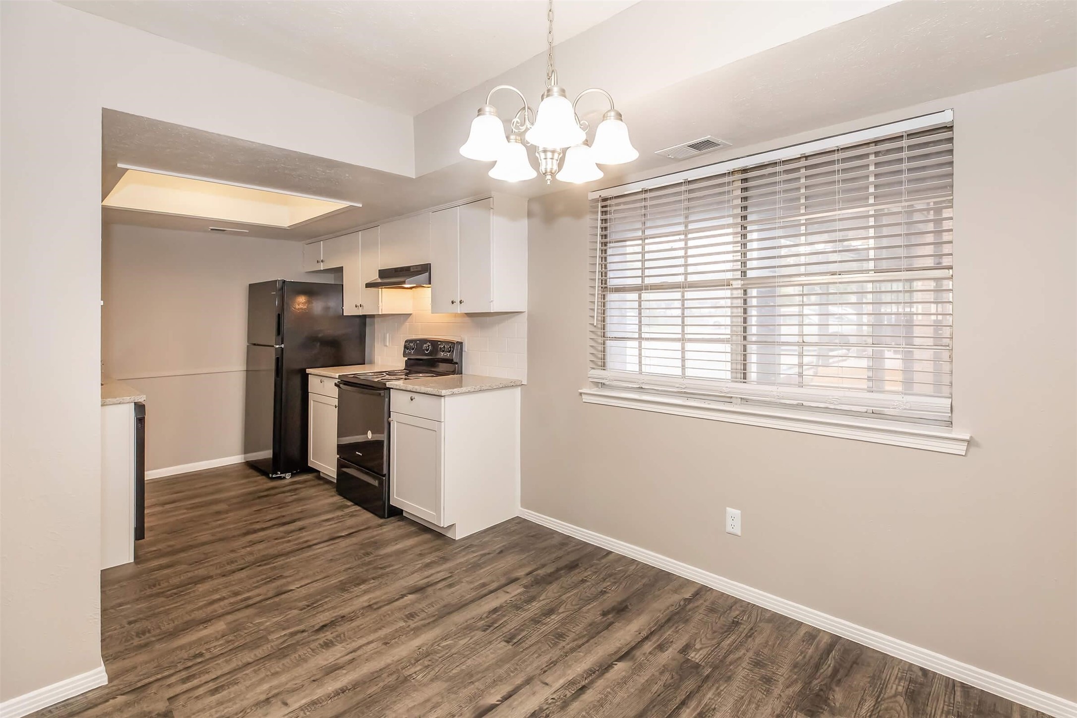 1212 Hampshire Lane, Unit 2371 Richardson, TX 75080 - Photo 25 of 50 a kitchen with kitchen island white cabinets and stainless steel appliances