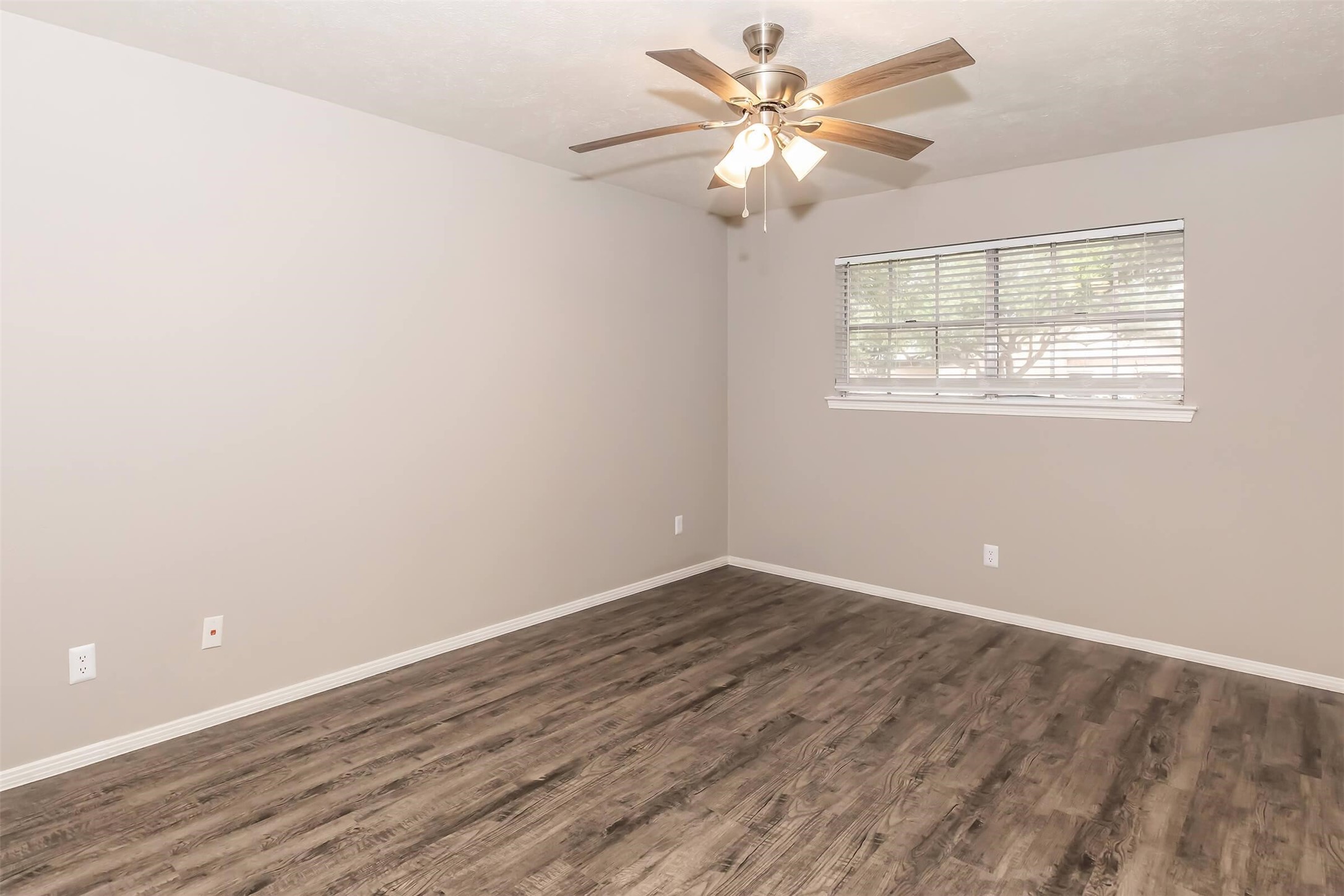 1212 Hampshire Lane, Unit 2371 Richardson, TX 75080 - Photo 26 of 50 an empty room with wooden floor fan and windows