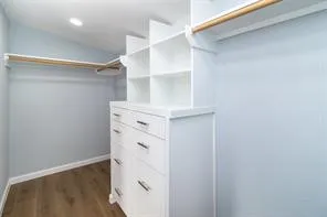 a view of walk in closet with empty racks
