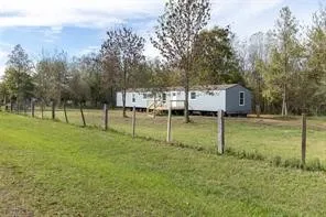 a backyard of a house with swimming pool and trees