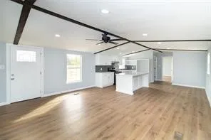a view of a kitchen with a sink and refrigerator