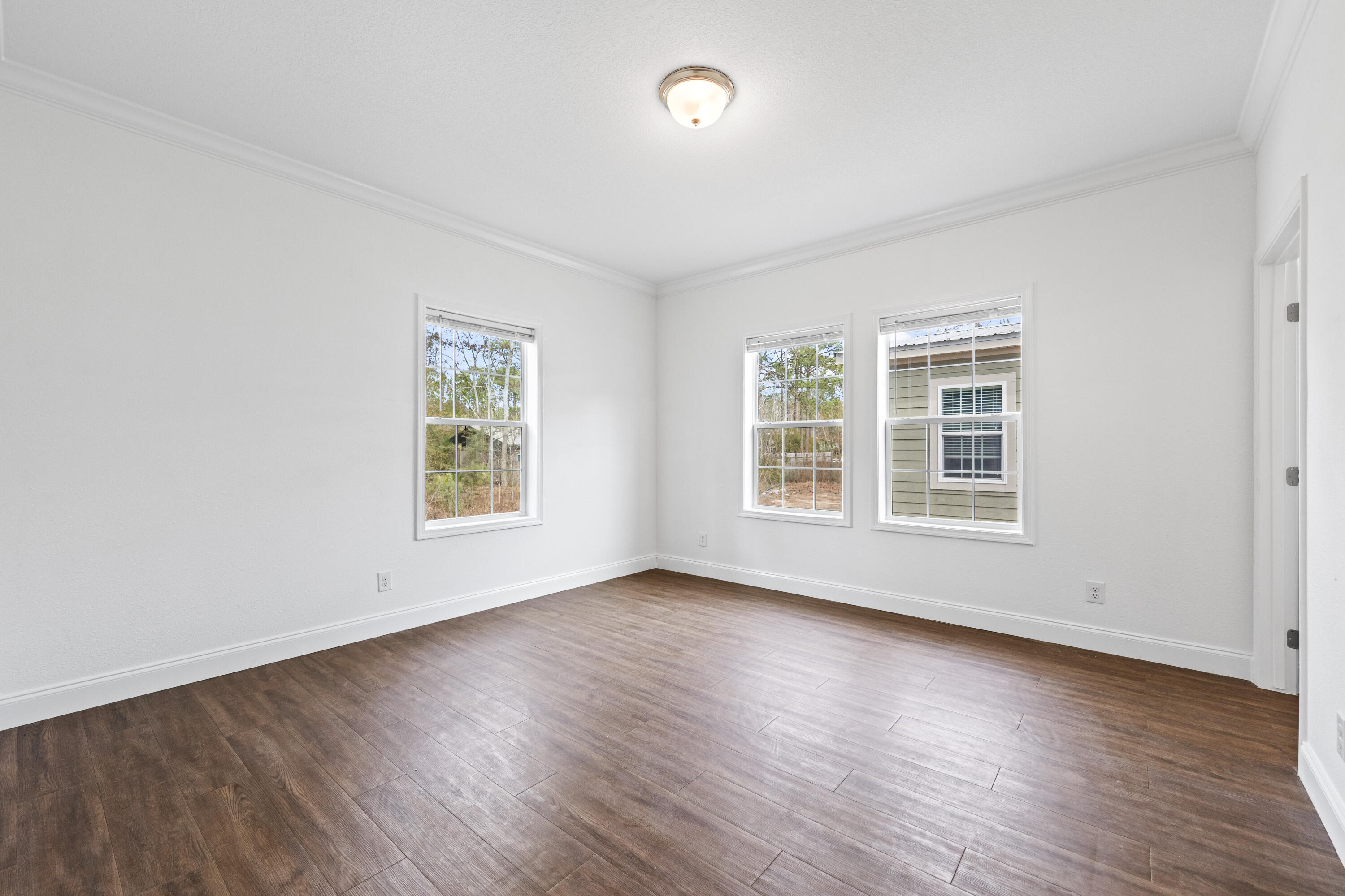 48 4th Street Santa Rosa Beach, FL 32459 - Photo 11 of 24 an empty room with wooden floor and windows