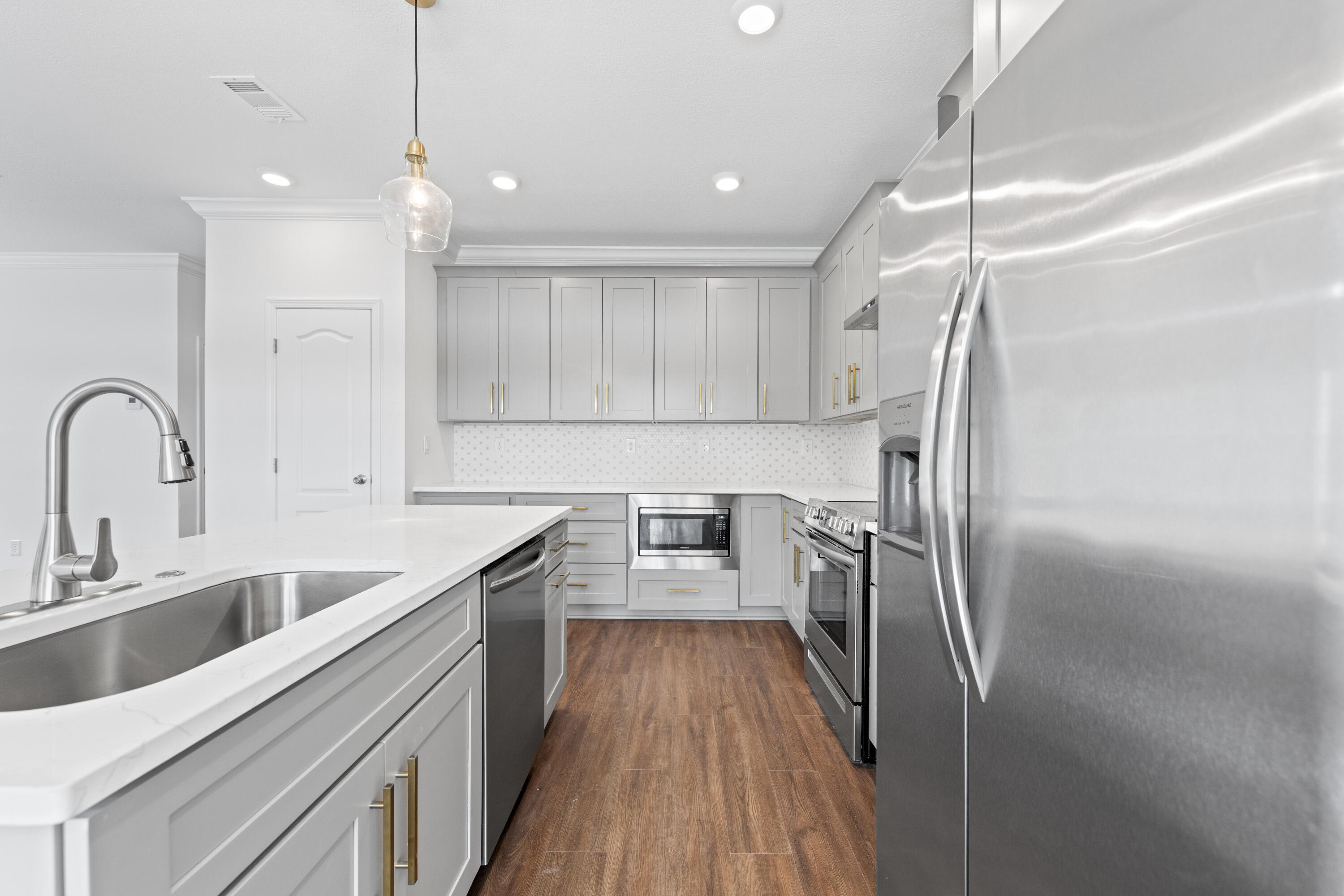 48 4th Street Santa Rosa Beach, FL 32459 - Photo 3 of 24 a kitchen with refrigerator cabinets and wooden floor