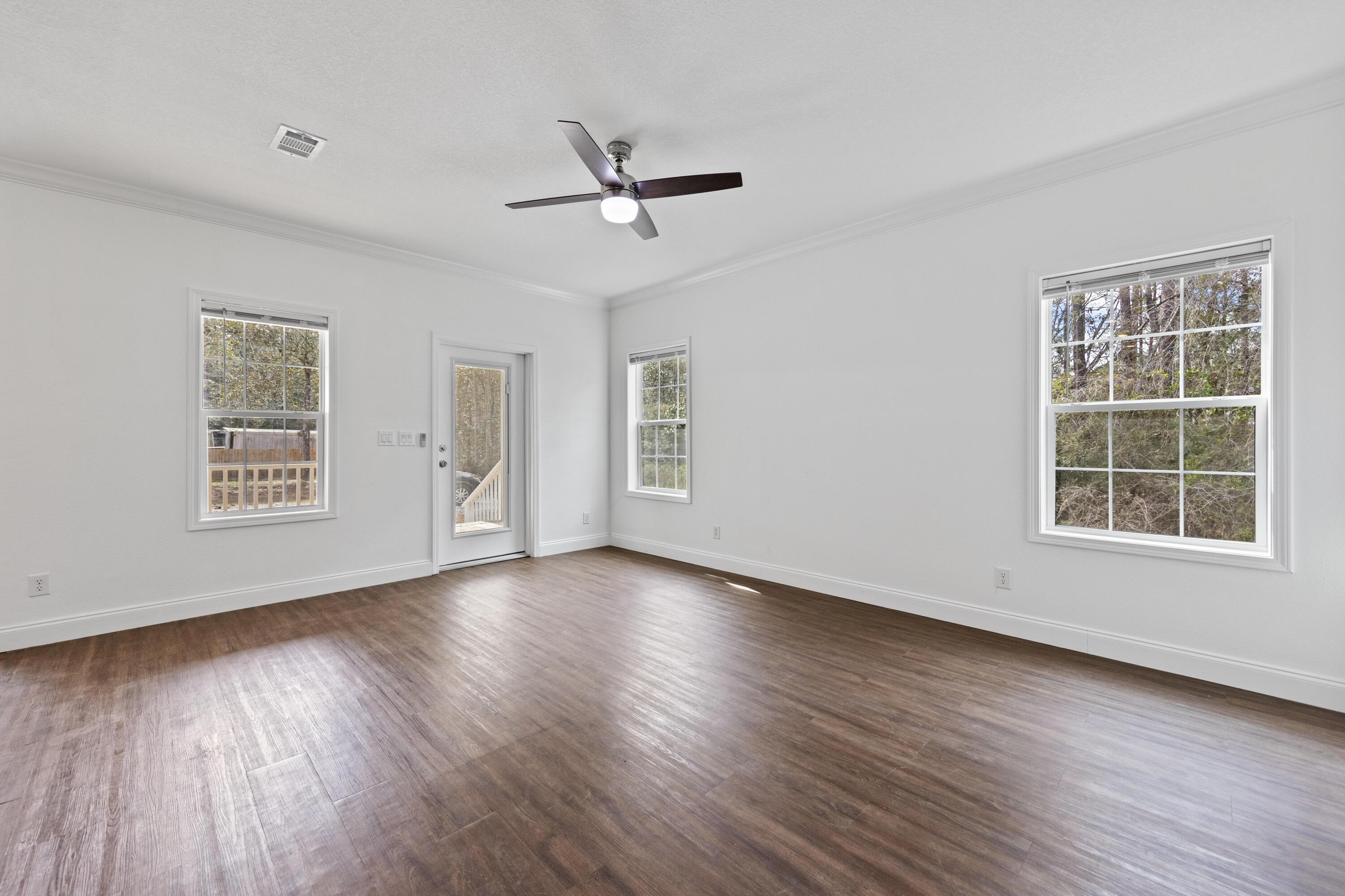 48 4th Street Santa Rosa Beach, FL 32459 - Photo 6 of 24 a view of an empty room with wooden floor and a window
