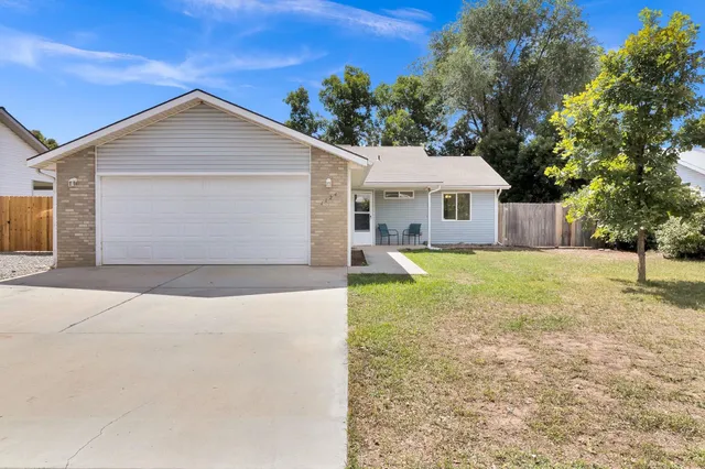 a front view of house with yard and trees