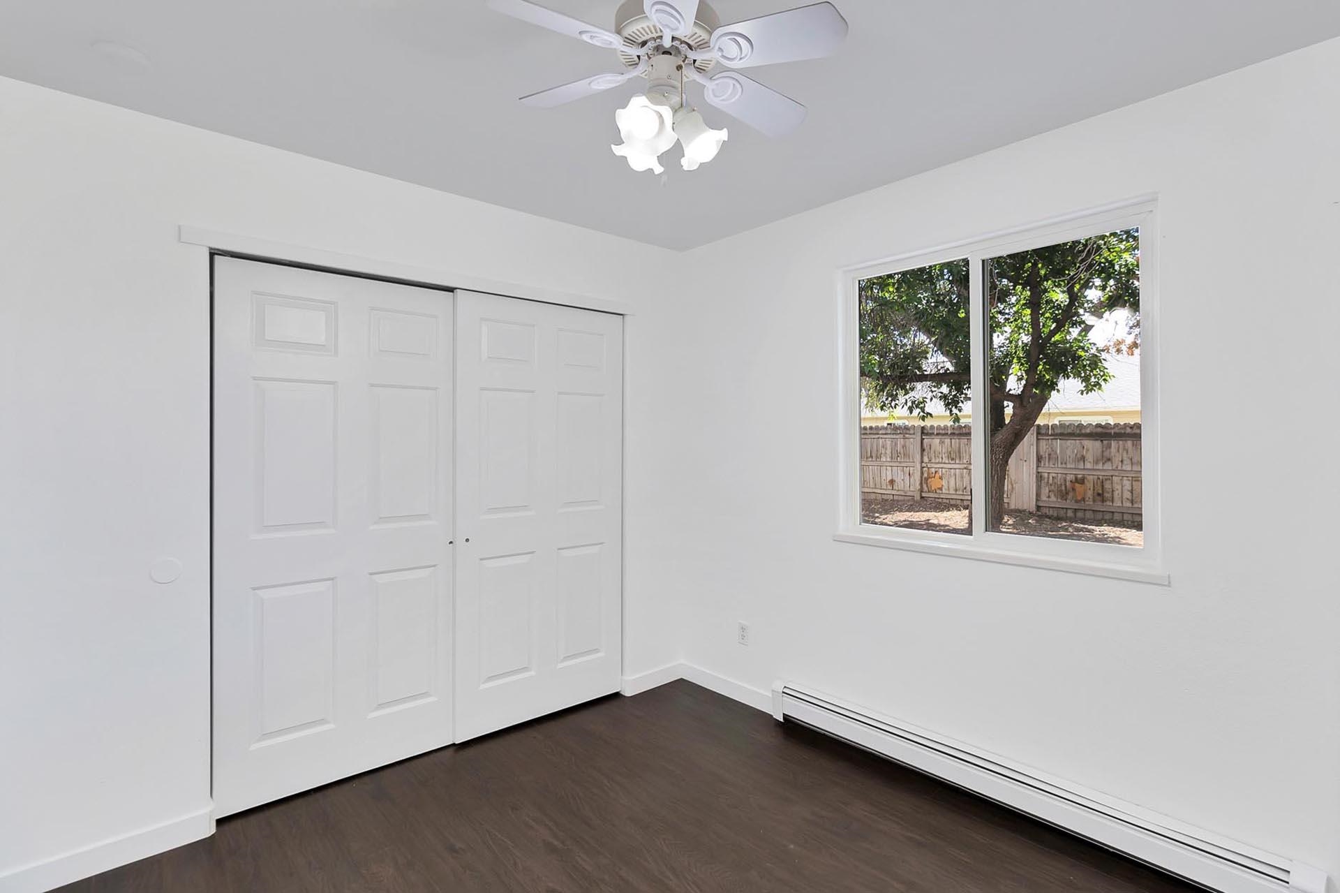 1124 Powell Street Fruita, CO 81521 - Photo 11 of 16 wooden floor in an empty room with a window