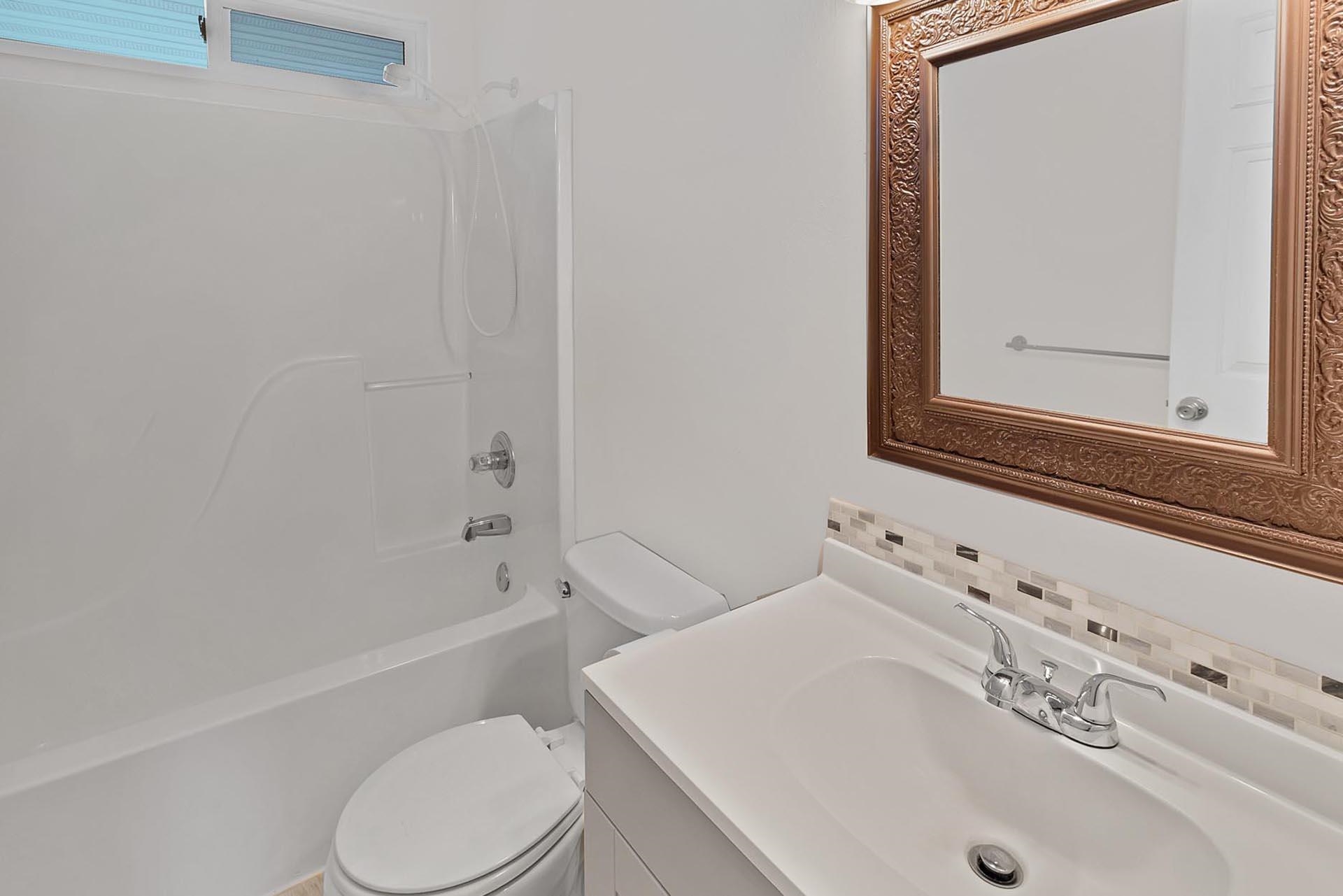 1124 Powell Street Fruita, CO 81521 - Photo 12 of 16 a bathroom with a sink a toilet and shower