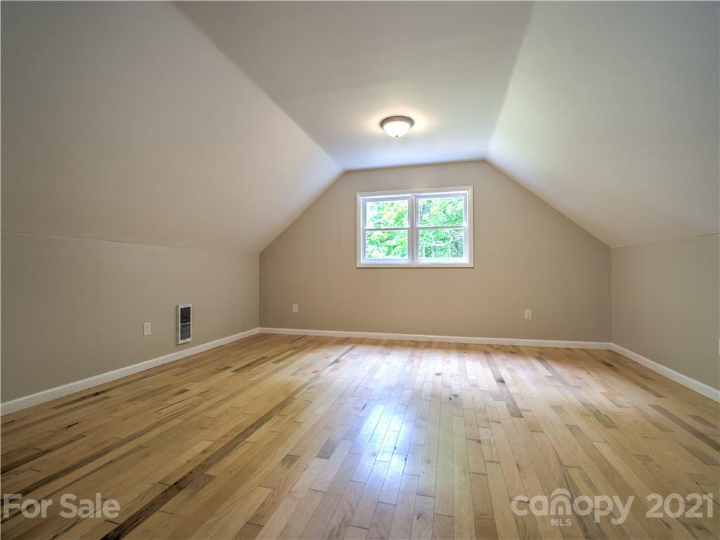 1778 Murray Road Canton, NC 28716 - Photo 22 of 42 an empty room with wooden floor and windows