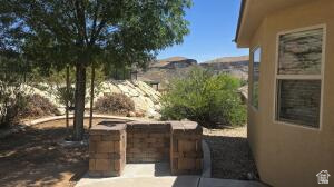 357 East 860 North Hurricane, UT 84737 - Photo 16 of 19 Outdoor patio area featuring a built-in stone block structure, concrete paving, and a mature shade tree