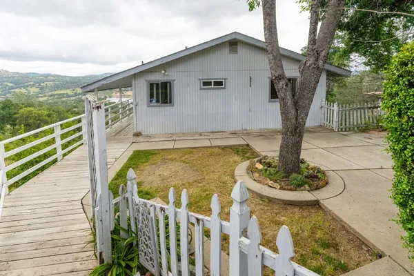 a front view of house with a garden and patio