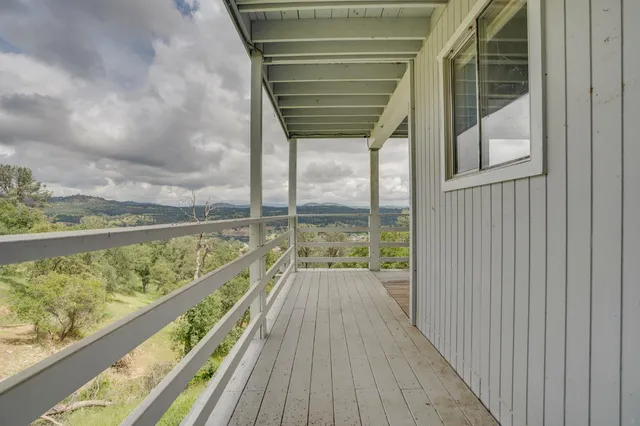 a view of balcony with wooden floor