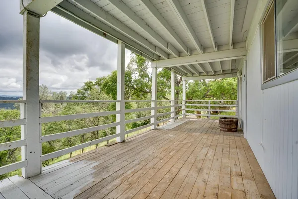 a view of a balcony with wooden floor