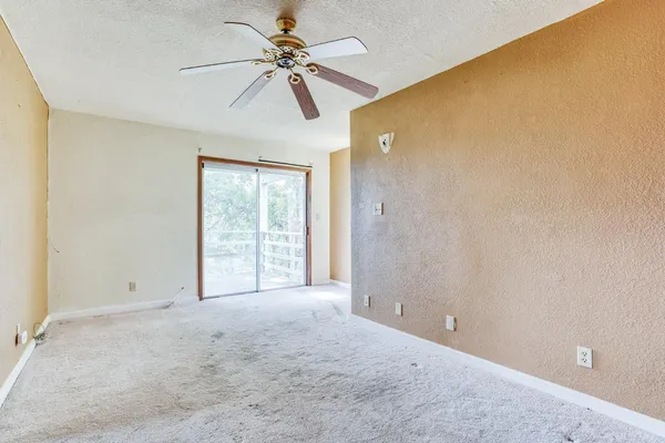 an empty room with projector and closet