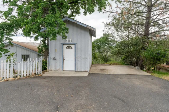 a view of a house with a tree