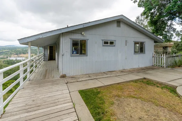 a view of a house with wooden deck