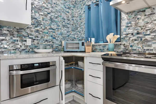 a kitchen with stainless steel appliances a stove and a sink